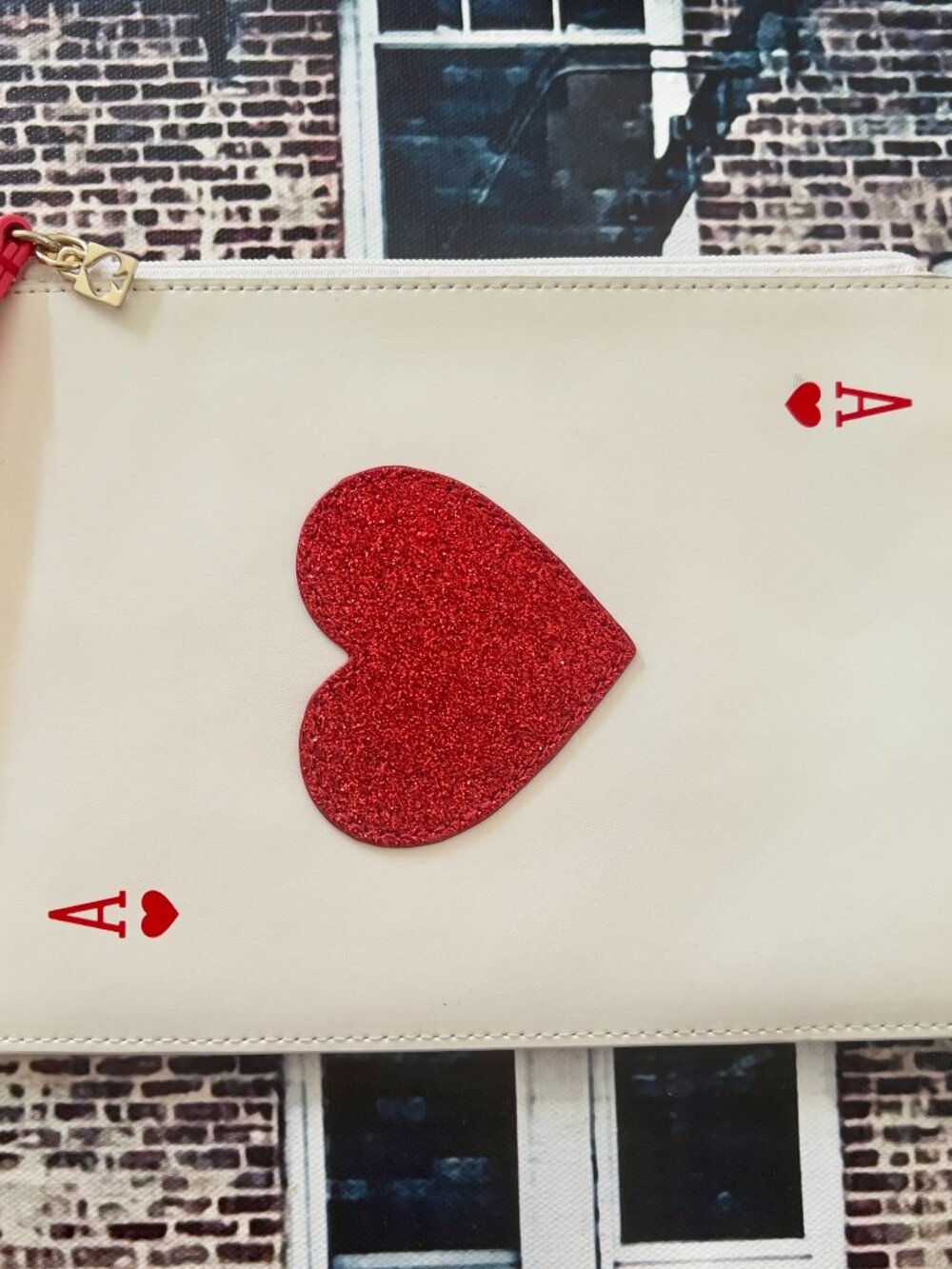 This is a Kate Spade New York "Place Your Bets" Medium Bella Wristlet